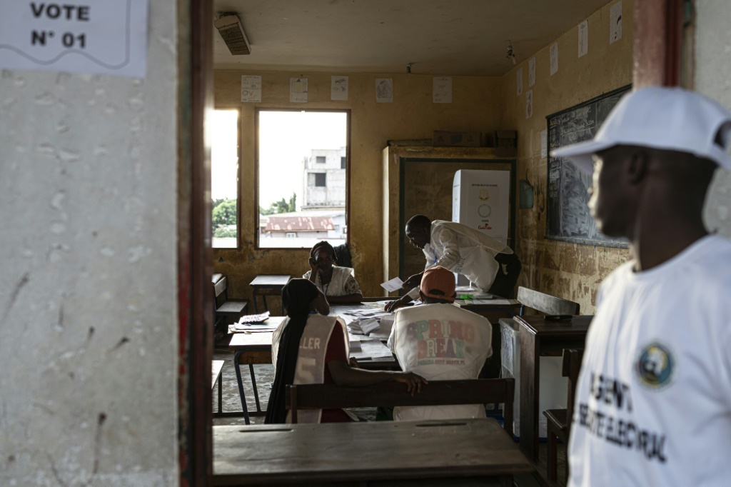 Des employés de la Direction générale des élections de Guinée (DGE) procèdent au comptage des voix le 21 septembre 2025 d'un bureau de vote situé dans l'école primaire de Taouyah, dans la capitale Conakry. Quatre ans après la prise de pouvoir des militaires, la junte a soumis au vote un projet de nouvelle Constitution.