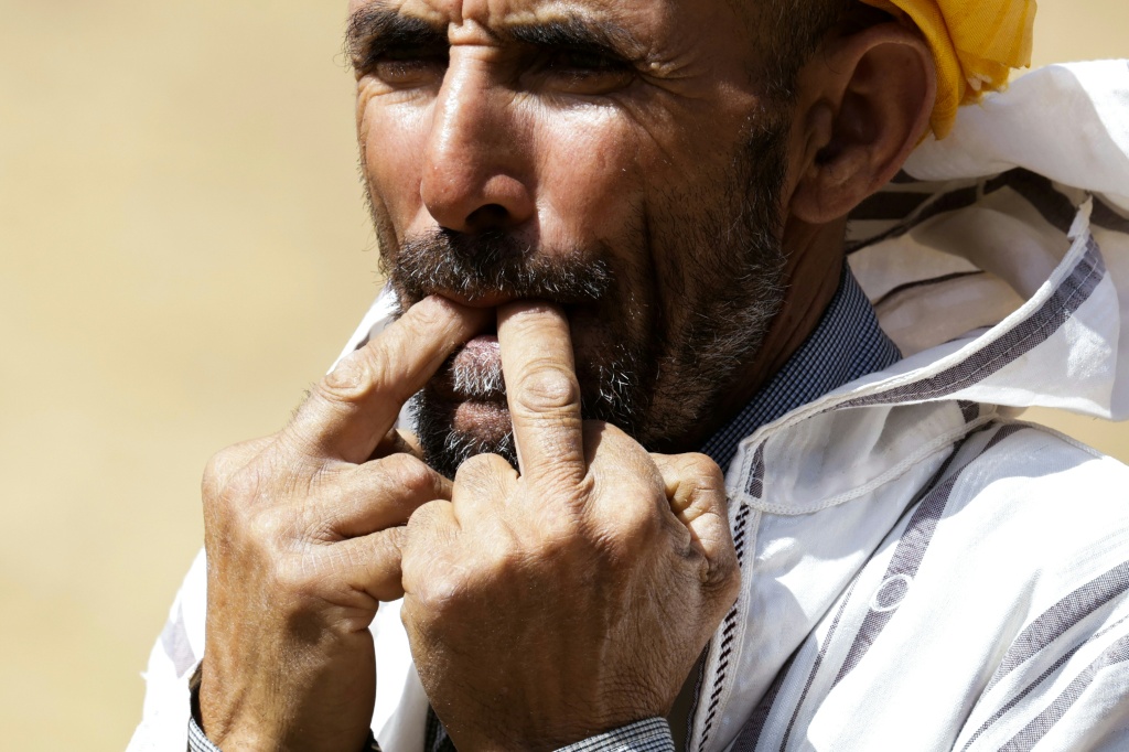 Un habitant du hameau d'Imzerri utilise la pratique ancienne du langage sifflé, permettant de communiquer à travers de vastes distances, le 19 août 2025 dans les montagnes de l'Atlas, au Maroc.