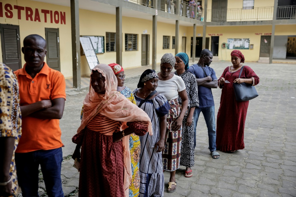 Des électeurs attendent de voter pour la présidentielle ivoirienne dans le quartier de Yopougon, à Abidjan, le 25 octobre 2025.