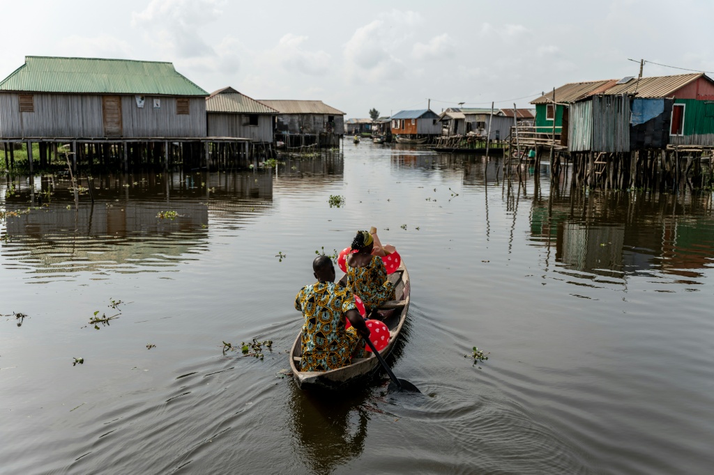 Un couple en pirogue quittent la 'Place des Amoureux' après avoir fêté la Saint-Valentin dans la ville lacustre de Ganvié, le 10 février 2026 au Bénin.