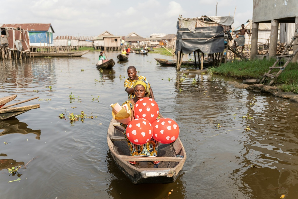 Un couple en pirogue quittent la 'Place des Amoureux' après avoir fêté la Saint-Valentin dans la ville lacustre de Ganvié, le 10 février 2026 au Bénin.