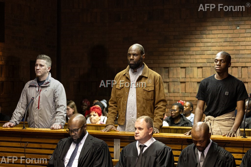 L'influenceur panafricaniste Kemi Seba, (c), son fils Khonsou Seba Capo Chichi (d) et le leader du groupe identitaire afrikaners Bittereinders, François van der Merwe (g) lors de leur comparution au Tribunal de Pretoria, le 20 avril 2026 en Afrique du Sud.
