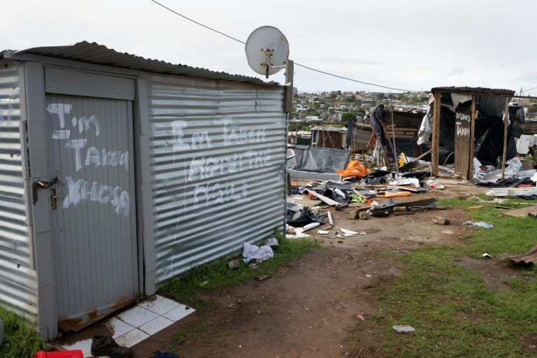 Un message "Je suis occupé, Xhosa" tagué sur les portes de baraques à Mossel Bay, le 4 juin 2026 en Afrique du Sud.